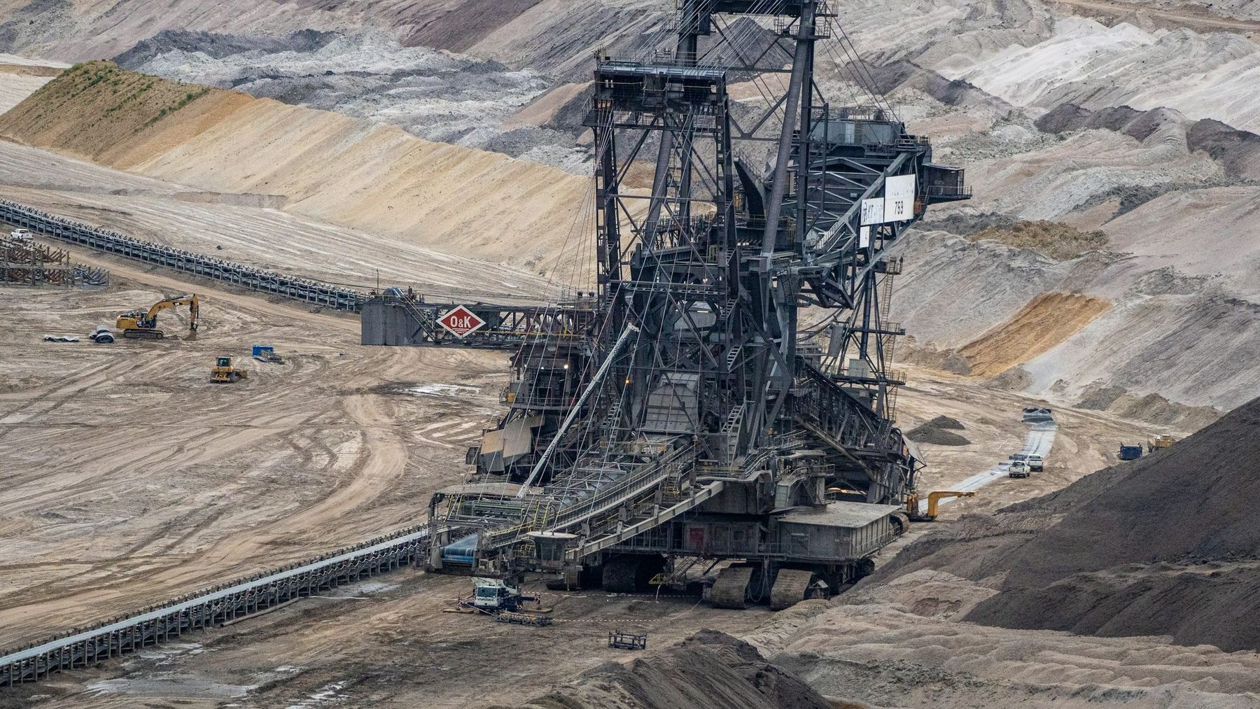 Bucket-wheel excavator and conveyor in an opencast mine